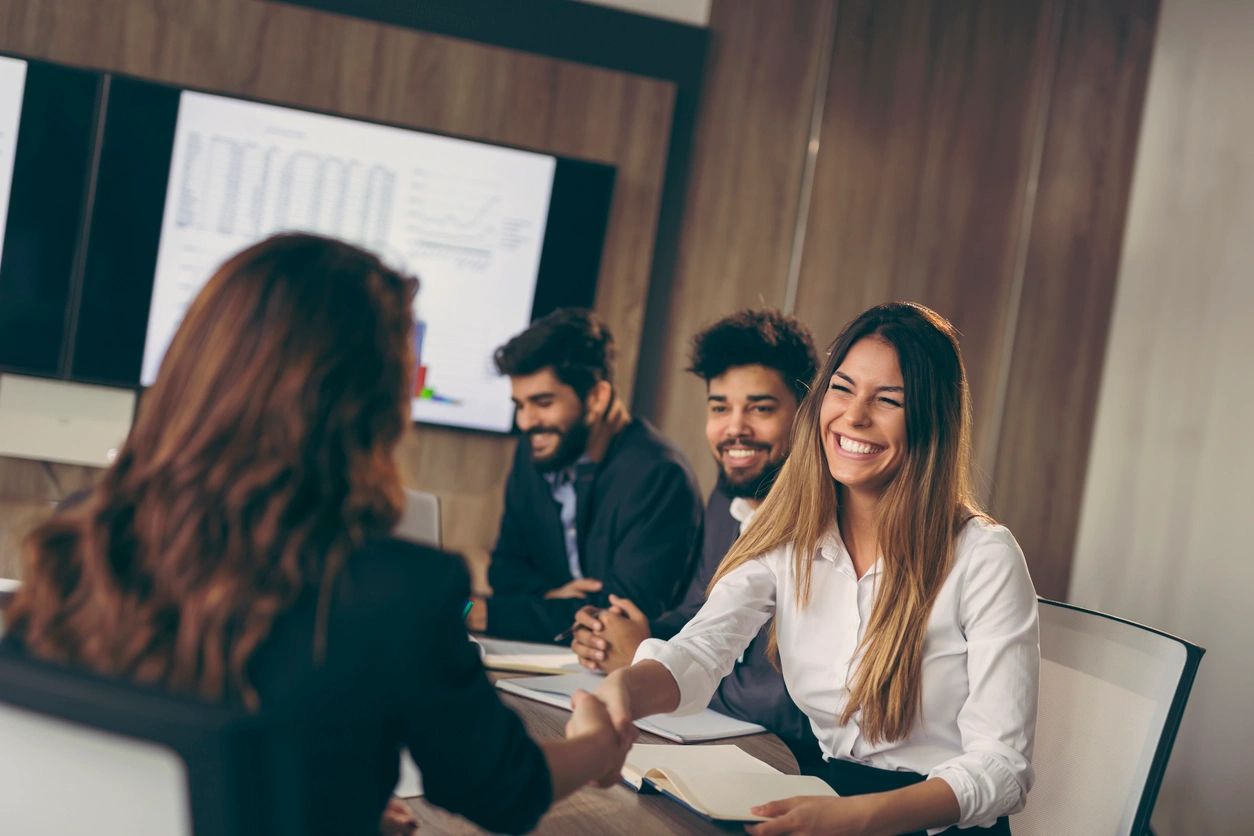 Business woman on a job interview, shaking hands with the human resources representative